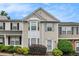 Charming townhouse with bay window, light siding, and manicured landscaping in a well-maintained community at 1310 Kilmington Ct, Alpharetta, GA 30009
