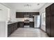 Stylish kitchen boasting stainless steel appliances, dark wood cabinets, and bright counter tops at 1310 Kilmington Ct, Alpharetta, GA 30009