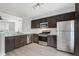 Well-appointed kitchen featuring stainless steel appliances, dark cabinets, and an open layout to living space at 1310 Kilmington Ct, Alpharetta, GA 30009