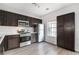 Modern kitchen with stainless steel appliances, dark cabinetry, and ample storage space at 1310 Kilmington Ct, Alpharetta, GA 30009