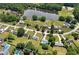 An aerial view shows the home's location in a community with a pond, mature trees, and neighborhood pools at 472 Linda Ln, Powder Springs, GA 30127