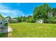 Spacious backyard featuring a lush lawn, mature trees, a patio area, and a shed with ample outdoor space at 472 Linda Ln, Powder Springs, GA 30127