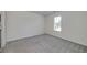 Spacious bedroom with neutral carpeting, ample natural light, and a blank canvas for personal touches at 472 Linda Ln, Powder Springs, GA 30127