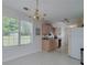 Bright dining area with chandelier, window views, and a seamless transition to the kitchen at 472 Linda Ln, Powder Springs, GA 30127