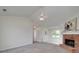 Bright living room features a brick fireplace, vaulted ceiling with fan, and ample natural light at 472 Linda Ln, Powder Springs, GA 30127