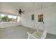 A quaint porch features a swing, fan, white paneling, and windows offering outdoor views at 472 Linda Ln, Powder Springs, GA 30127