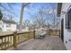 Outdoor deck features a charming striped bench, wooden railings, and views of the backyard at 953 Michigan Ave, Atlanta, GA 30314