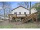 Backyard view featuring a wooden deck, grassy yard, and mature trees at 953 Michigan Ave, Atlanta, GA 30314