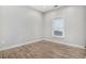 Bright bedroom with wood-look floors and ample natural light from a large window at 953 Michigan Ave, Atlanta, GA 30314