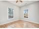 Cozy bedroom featuring wood floors, a ceiling fan, and ample natural light at 953 Michigan Ave, Atlanta, GA 30314