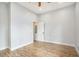 Empty bedroom with wood flooring, a ceiling fan, neutral walls, and a single door at 953 Michigan Ave, Atlanta, GA 30314