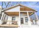 Charming bungalow showcasing a welcoming front porch with exposed rafter tails and a cozy seating area at 953 Michigan Ave, Atlanta, GA 30314