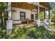 Inviting front porch with wood flooring and brick accents, perfect for relaxing outdoors at 953 Michigan Ave, Atlanta, GA 30314