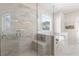 Luxurious bathroom featuring a glass-enclosed shower with marble tile and a relaxing soaking tub with view at 3345 Hillshire Dr, Cumming, GA 30028