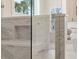 Luxurious bathroom featuring a glass-enclosed shower with marble tile and a shower seat at 3345 Hillshire Dr, Cumming, GA 30028