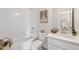 Bright bathroom featuring a shower and tub combo, white subway tile, white sink, and framed wall art at 3345 Hillshire Dr, Cumming, GA 30028