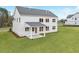 Rear exterior view of the home with ample green space in the backyard at 3345 Hillshire Dr, Cumming, GA 30028