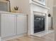 Close up of a modern fireplace with marble surround, flanked by stylish built-in cabinets for storage at 3345 Hillshire Dr, Cumming, GA 30028
