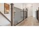 Hallway featuring wooden floors and wood banister with black iron railing at 3345 Hillshire Dr, Cumming, GA 30028