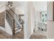 Spacious hallway with a staircase leading to the upper level and a view of the adjacent office space at 3345 Hillshire Dr, Cumming, GA 30028