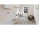 Spacious laundry room with tiled floors, utility sink, and overhead cabinets for ample storage at 3345 Hillshire Dr, Cumming, GA 30028