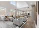 Bright and airy living room featuring hardwood floors, large windows, and open access to the kitchen at 3345 Hillshire Dr, Cumming, GA 30028