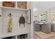 Mudroom featuring built-in storage, with view through to open plan dining and living areas at 3345 Hillshire Dr, Cumming, GA 30028