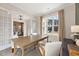 Well-lit office with a large window, wooden desk, and a glimpse into the elegant dining room at 3345 Hillshire Dr, Cumming, GA 30028