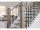 Detailed staircase featuring wood treads and iron balusters, providing an elegant transition between floors at 3345 Hillshire Dr, Cumming, GA 30028