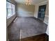 Bright living room boasts abundant natural light, neutral tones, and large windows overlooking the neighborhood at 5704 Winchester Pl, Lithonia, GA 30038