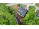 Aerial shot of a home with a deck, firepit, and a lush green landscape at 681 Braidwood Nw Ter, Acworth, GA 30101