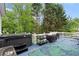 Spacious deck equipped with a hot tub, grill, and lush green trees in the background at 681 Braidwood Nw Ter, Acworth, GA 30101