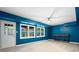 Finished basement with bright blue accent walls, recessed lighting, ceiling fan, and walk-out access to the backyard at 681 Braidwood Nw Ter, Acworth, GA 30101