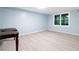 Unfinished basement space with a light blue wall, light wood-look floors, and a window offering natural light at 681 Braidwood Nw Ter, Acworth, GA 30101