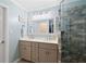 Well-lit bathroom featuring double vanity, decorative wall mirror, and tiled shower at 681 Braidwood Nw Ter, Acworth, GA 30101
