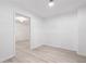 Bright, clean bedroom space with fresh white paint, modern light fixture, and sleek wood-look flooring at 681 Braidwood Nw Ter, Acworth, GA 30101