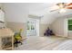 Attic bedroom with a bright window nook, angled ceilings, and light, hardwood floors at 681 Braidwood Nw Ter, Acworth, GA 30101