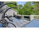 Relaxing backyard deck complete with outdoor furniture, lush greenery, and a peaceful outdoor ambiance at 681 Braidwood Nw Ter, Acworth, GA 30101