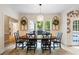 A formal dining room offers wood floors, designer wallpaper, wainscoting, and a modern chandelier at 681 Braidwood Nw Ter, Acworth, GA 30101