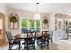 A formal dining room offers wood floors, designer wallpaper, wainscoting, and a modern chandelier at 681 Braidwood Nw Ter, Acworth, GA 30101
