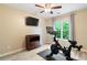 Exercise room with hardwood flooring, bright window, and Peloton exercise bike at 681 Braidwood Nw Ter, Acworth, GA 30101