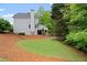Home exterior with green lawn and treed backdrop at 681 Braidwood Nw Ter, Acworth, GA 30101