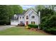 Charming two-story home featuring a red front door and lush landscaping at 681 Braidwood Nw Ter, Acworth, GA 30101