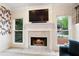 Elegant fireplace with marble hearth, television, and decorative mantel at 681 Braidwood Nw Ter, Acworth, GA 30101