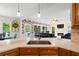 This kitchen offers marble countertops and a stainless steel sink adjacent to the Gathering room at 681 Braidwood Nw Ter, Acworth, GA 30101