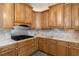 A traditional style kitchen offers custom cabinetry, marble countertops, and a stainless steel range at 681 Braidwood Nw Ter, Acworth, GA 30101