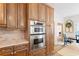 A traditional style kitchen offers stainless steel appliances, custom cabinetry, and views into the dining area at 681 Braidwood Nw Ter, Acworth, GA 30101