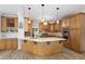 A traditional style kitchen offers a spacious island and custom wood cabinetry and modern lighting at 681 Braidwood Nw Ter, Acworth, GA 30101