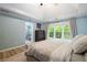 Cozy main bedroom offers a tray ceiling, ensuite bathroom and nature views at 681 Braidwood Nw Ter, Acworth, GA 30101