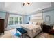 Serene bedroom with tray ceilings, neutral decor, and bright, scenic windows at 681 Braidwood Nw Ter, Acworth, GA 30101